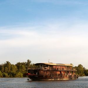a_wooden_cabin_cruiser_in_the_late_afternoon_on_the_mekong.jpeg