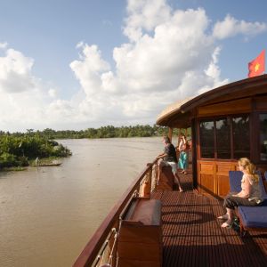 lounging_on_the_upper_deck_as_the_bassac_cruises_mang_thit_river.jpeg