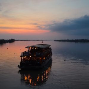 wooden_cabin_cruiser_at_dawn_on_the_mekong_delta.jpeg